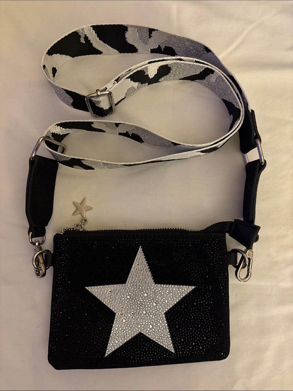 “Vintage Havana” black crossbody bag with silver star and adjustable strap.